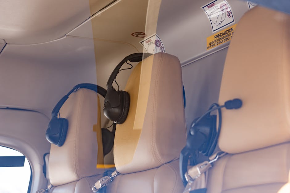 Close-up of a luxurious helicopter interior with leather seats and headphones.